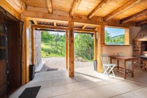an open living room with a table and a desk at Kuća za odmor Dangubica in Kuterevo