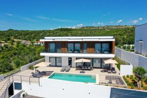 an aerial view of a house with a swimming pool at Luxury villa del Sol in Novalja