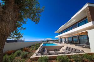 an external view of a house with a swimming pool at Luxury villa del Sol in Novalja