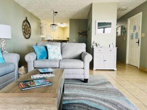 a living room with a couch and a table at Elegant Coastal Getaway Spacious 3BR Chelsea House in Myrtle Beach