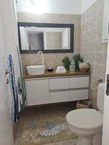 a bathroom with a sink and a toilet at Studio Caroline in Eilat