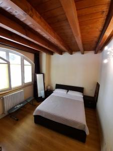 a bedroom with a bed and a large window at Silenzioso, posto auto, 2km da Lodi, 30 km da Milano in San Martino In Strada