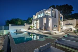 a villa with a swimming pool at night at Ventus Villa - A Luxury Sea View Retreat in Akrotiri in Akrotiri