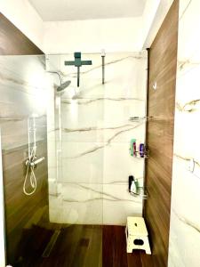 a bathroom with a shower with a glass door at Villa Katerina in Kos +30 photos