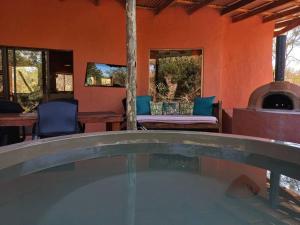 an outdoor hot tub in a house with a fireplace at The Eco Hut in Hoedspruit