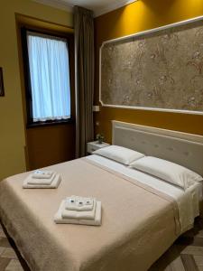 a bedroom with a bed with two towels on it at B&B Fiorentino in Lamezia Terme