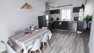 a kitchen and dining room with a table and chairs at Azure Sunset in Ponta Delgada
