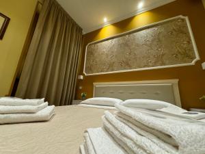 a bedroom with two beds with white towels on them at B&B Fiorentino in Lamezia Terme