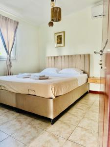a large bed in a bedroom with a window at Villa Katerina in Kos