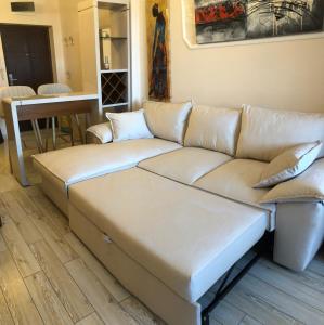 a leather couch in a living room with a table at Апартамент VESI комплекс ARTUR in Sveti Vlas +72 photos