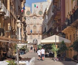 a group of people walking down a street with a building at TETIDE Holiday home,casa vacanze in Trapani