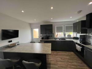 a kitchen with a large island in the middle at Ardenslate House in Kirn
