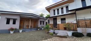 two buildings with potted plants in front of them at Villa Kendra in Moalboal