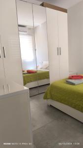 a bedroom with two beds and a mirror at One bedroom TEA apartment Il-Gzira in Il-Gżira