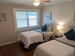 a bedroom with two beds and a window at Pine Valley Place 3 Bedroom 2 Bathroom house in Gainesville