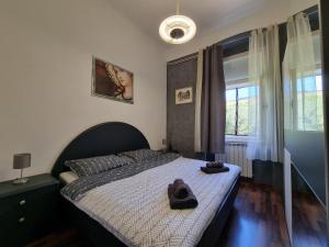 a bedroom with a bed with a pair of shoes on it at SubCastrum Apartments in Pula