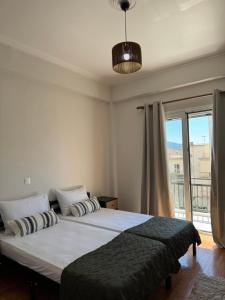 a bedroom with a large bed and a large window at Molys House in Igoumenitsa