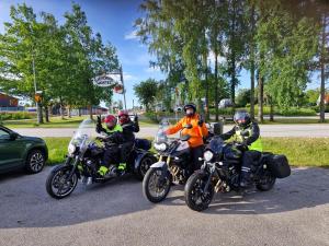a group of people riding motorcycles on a street at SJÖTORPS HOSTEL in Sjötorp