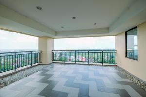 a balcony with a view of a city at Comfy and Tidy Studio Transpark Cibubur Apartment By Travelio in Depok