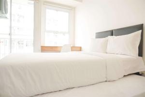Ένα ή περισσότερα κρεβάτια σε δωμάτιο στο Modern and Nice Studio Citra Living Apartment By Travelio +11 φωτογραφίες