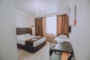 Postel nebo postele na pokoji v ubytování Royal Medis Hotel