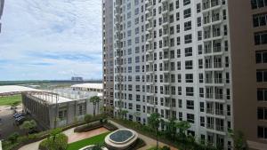 an aerial view of a large white building at Good and Restful Studio at Tokyo Riverside PIK 2 Apartment By Travelio in Rawalembang
