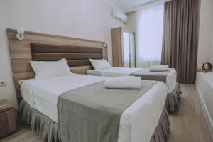 Postel nebo postele na pokoji v ubytování Royal Medis Hotel
