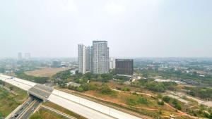 an aerial view of a city with tall buildings at Comfy Stay Studio at Sky House BSD Apartment By Travelio in Tangerang