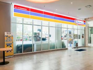 a store front with a colorful sign on the wall at Strategic and Best Deal Studio at Apartment B Residence By Travelio in Tangerang +16 photos