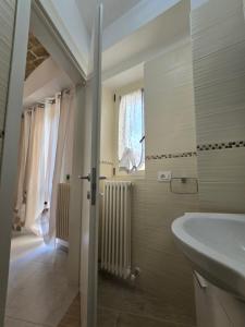 a bathroom with a sink and a tub and a window at Perla -Centro Storico Vasto- in Vasto +111 photos