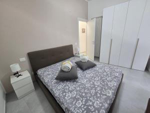 a bedroom with a bed with two pillows on it at Perla -Centro Storico Vasto- in Vasto