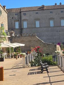 a bench sitting in front of a building at Perla -Centro Storico Vasto- in Vasto
