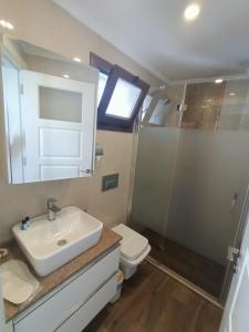 a bathroom with a sink and a toilet at R A Rolex Alsancak in Konak +13 photos
