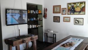 a living room with a tv and a table at Pousada São Pedro in Olinda