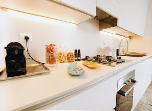 a kitchen with a counter top with a stove at Casa Bianca in Otranto