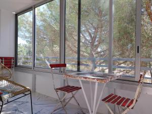 a table and two chairs in front of a window at Miggle-Moo-Sea in Argelès-sur-Mer