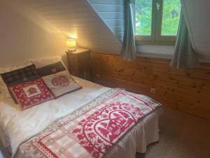 a bedroom with a bed with pillows on it at Villa du Lys Bagnères de Luchon in Luchon