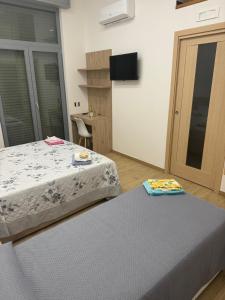 a bedroom with two beds and a tv in it at B&B Stella Irpina in Teora