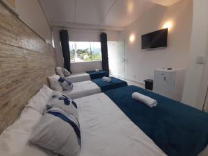 En eller flere senge i et værelse på POUSADA PARAISO da BARRA DA TIJUCA