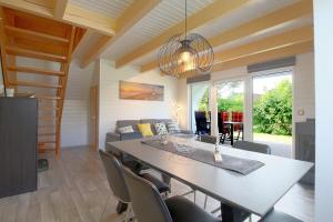 a dining room and living room with a table and chairs at SR Knechtsand 2 in Dorum Neufeld