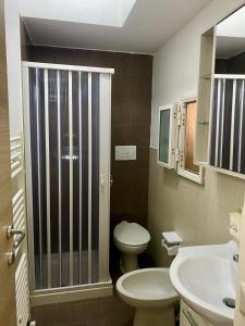 a bathroom with a toilet and a sink and a shower at casa di zia Flora in Fasano