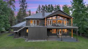 a house with a large deck on a lawn at Pony Express 7 in Bend