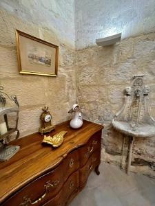 a room with a wooden dresser and a sink at Le Presbytère de Maître Jacques in Arles +22 photos