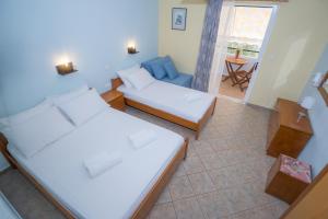 een kleine kamer met 2 bedden en een bank bij Sofia and Soul Studios in Kalamitsi