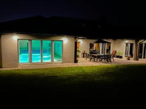 a house with a patio with a view of the ocean at Siedlisko Błotnia in Mierzeszyn