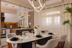 a dining room with a table and chairs and a kitchen at Marina 7 Resort By Seven Seasons in El Alamein