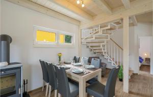 a dining room with a table and a spiral staircase at Ferienhausdorf Thale in Thale