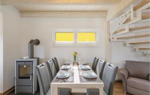 a dining room with a table with chairs and a staircase at Ferienhausdorf Thale in Thale +34 photos