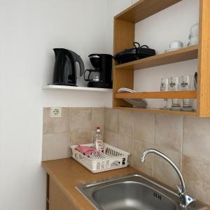 a kitchen sink with a dish drying rack next to it at Panagiotis Rooms in Naousa +87 photos