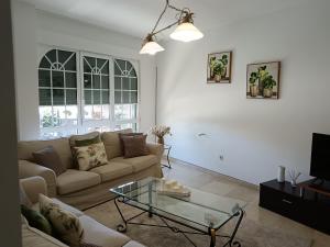 a living room with a couch and a glass table at Casa Beatriz in Cambados